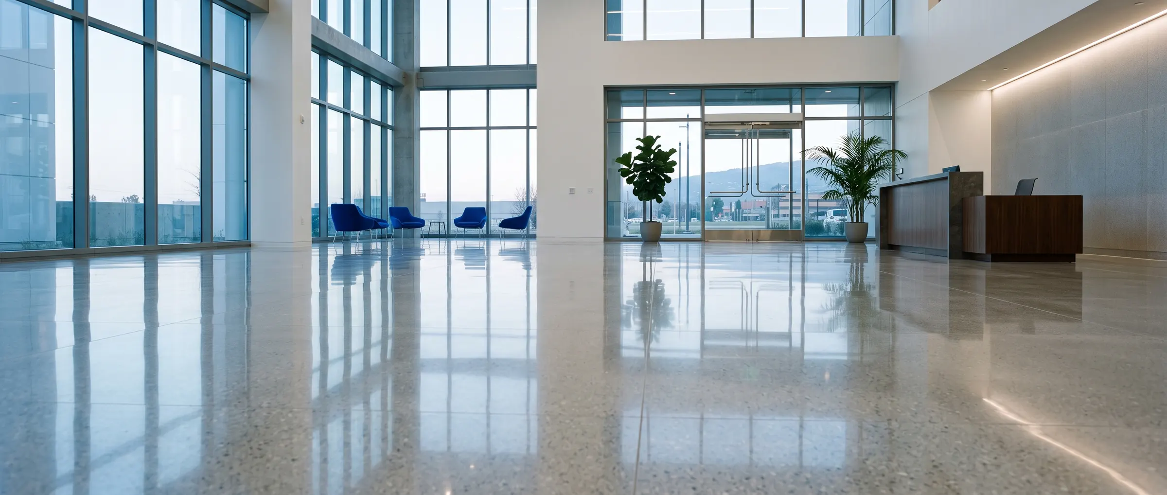 The same lobby after cleaning, with a polished floor reflecting the windows